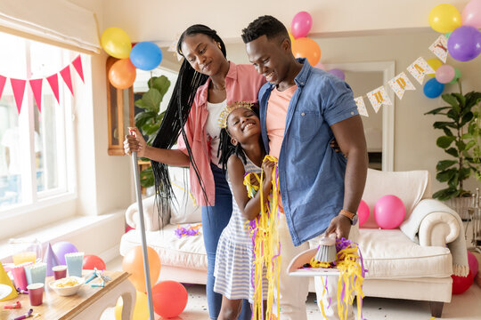 African American family celebrating birthday at home with balloons and decorations