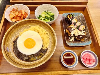 Korean comfort food set — jajangmyeon with fried egg, pickled radish, and kimbap rolls