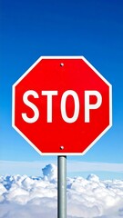 Obraz premium Red octagonal stop sign against a clear blue sky with puffy white clouds