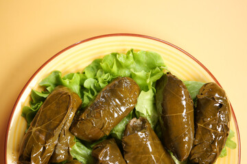 Stuffed grape leaves served on a bed of fresh lettuce