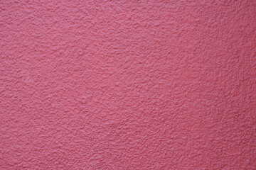 Textured pink wall captures subtle light and shadows