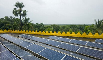 Solar panels system on rooftop on building with tree forest background. 