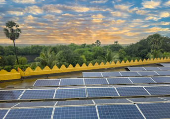 Beautiful view of solar panels with dramatic sky and forest background.