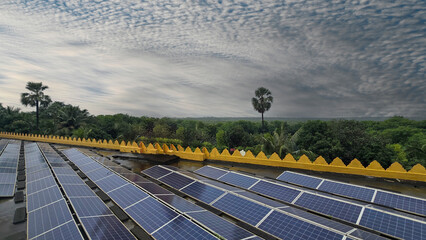 Beautiful view of solar panels with dramatic sky and forest background.