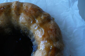 Close-up of homemade bundt cake with shiny caramel glaze, rustic autumn dessert for cozy seasonal...