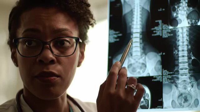 A terrified man raises his hands in surrender, running frantically through a dark server room corridor