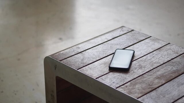 Smartphone resting on a wooden table. lost smart phone concept 