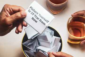 Man holding a piece of paper with the note picture yourself 10 years from now. Get to know your...