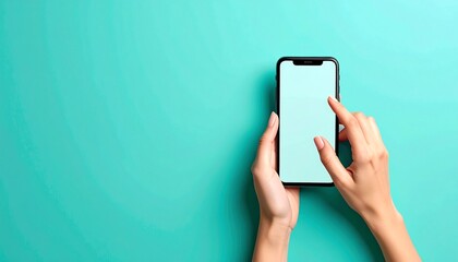 Hands holding a smartphone on a mint green background