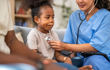 Doctor using stethoscope for medical checkup, listening to heartbeat and lungs of african child, father sitting beside, concept of pediatric healthcare, illness prevention, diagnosis and patient care