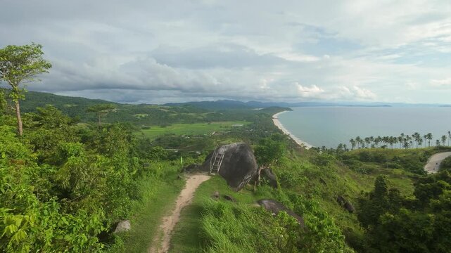 High-speed FPV drone flies low over the iconic Bato ni Ningning rock in San Vicente, Palawan, revealing the dramatic shoreline of Long Beach on the horizon.