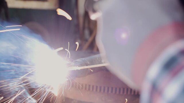 Back View Construction Industrial Factory or Metalwork Concept by Mechanic or Technician Welder Welding Ball Joint Auto Part
