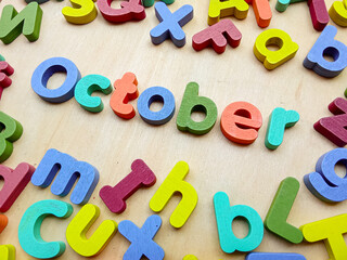 October wooden letter with colorful wooden letters background, back to school concept