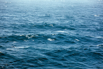 Blue sea water surface with waves and foam. Natural background. 