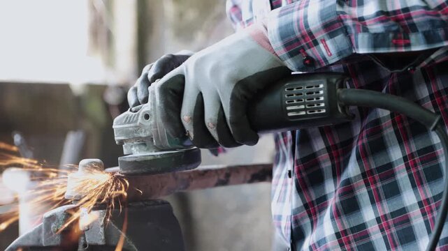 Track Shot Construction Industrial Factory or Metalwork Concept by Mechanic or Technician Using Grinder with Auto Part Workshop