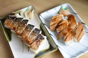 Two dishes: grilled mackerel sushi on a plate and boiled conger eel sushi on a plate / 焼き鯖寿司の皿盛りと煮穴子寿司の皿盛りの二品