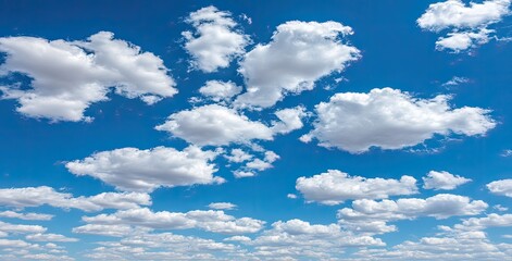 Vast blue sky scattered with puffy white clouds