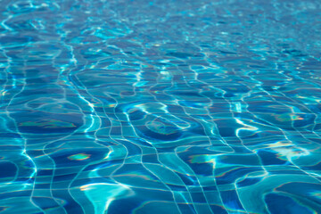 Sunlight creating beautiful ripples on swimming pool water surface