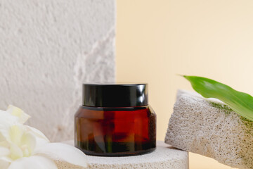Cosmetic bottles on a stone podium, Blank label package for mock up on a beige background. The...