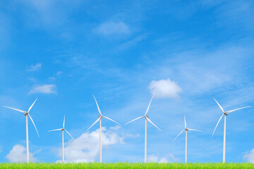 Wind Turbines in a Green Field: A picturesque image showcasing wind turbines standing tall against a bright, azure sky, with a field of vibrant green grass in the foreground.