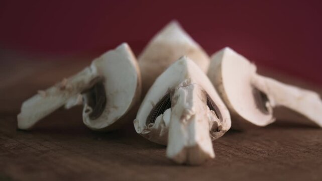 Four pieces of fresh portobello mushrooms surrounding it. Agaricus bisporus