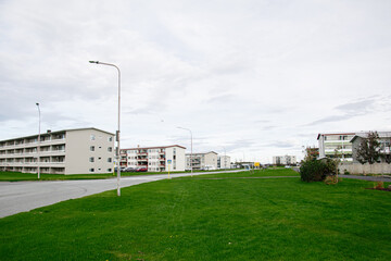 A residential neighborhood with green lawns in Akranes, Iceland on a cloudy day