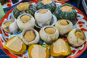 Traditional Thai custard dessert served in coconut and pumpkin, highlighting creamy texture, natural sweetness and authentic Thai culinary heritage.