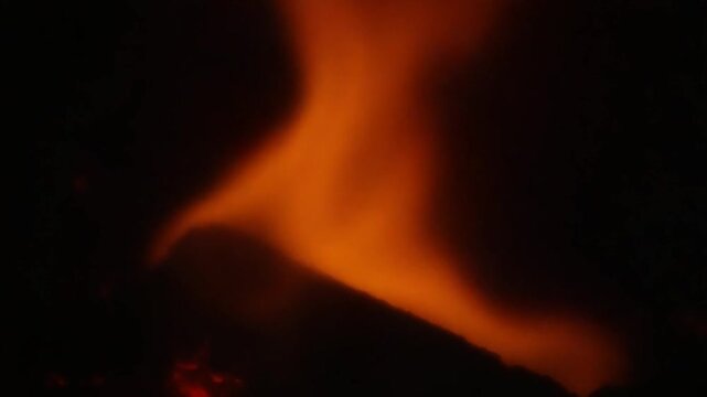 A close up of a fire burning in the dark
