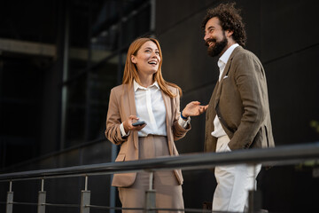 Businesspeople having a lively conversation outside office building