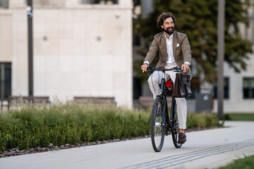Businessman riding bicycle in urban setting, embracing sustainable commute