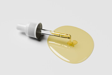 dropper filled with a golden liquid rests beside two drops of oil on a clean white surface, highlighting the elegance of skin care formulations in a minimalistic style. 3d render