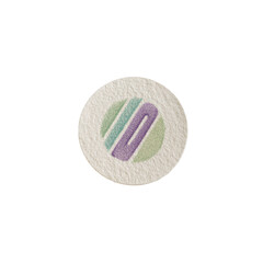 Small, round, light beige disc with a stylized, colorful, abstract design