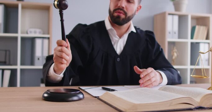 Trial, law court male judge, gavel wooden hammer bangs to sentence in court of law, accuse guilty, proclamation, passes judgment, hitting on table to get attention, punctuate rulings final decision