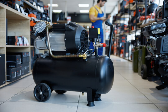 An air compressor positioned on the floor of a store