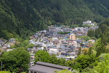 Fototapeta premium Close-up aerial view of Gujo Hachiman town, a small riverside town in Gifu Prefecture, Central Japan, known for its pristine waterways