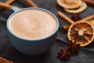 Hot chocolate in a blue cup with natural christmas decorations