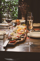 An Elegant Charcuterie Board that beautifully features Wine alongside a