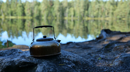 Kettle on Rock by Lake Water