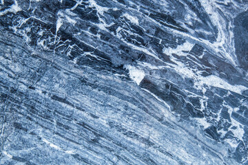 The pattern and surface of the blue, white and black marble walls for the background and tile design.