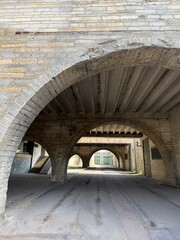 Arches and underpass with steps of Soviet era concrete building