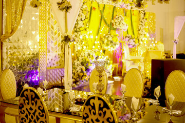 Elegant Event Space Decorated with Gold Accents and Floral Arrangements