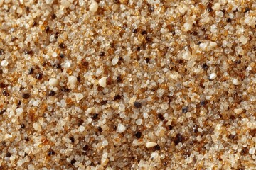 Fototapeta premium Close-up of sandy beach texture with pebbles