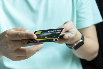 Woman holding several credit cards and he is choosing a credit card to pay and spend Payment for goods via credit card. Finance and banking concept	