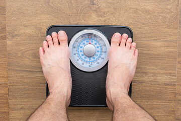 Legs of women standing on scales weight. Concept of health and weight loss
