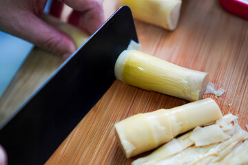 Chopping bamboo shoots on cutting board © Warintip