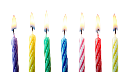 Colorful birthday candles, lit, against black