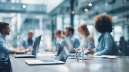 Business Professionals Meeting in Modern Office with Laptops and Water Glass