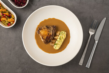 Roasted meat with mashed potatoes and brown sauce on plate