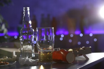 Messy table with beer and food leftovers indoors, space for text. After party chaos