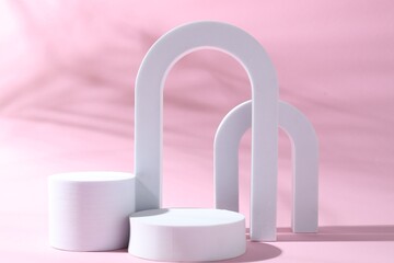 Promotion. Different podiums for product presentation on pink background